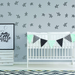 Baby crib with decorative flags against a wall with star patterns