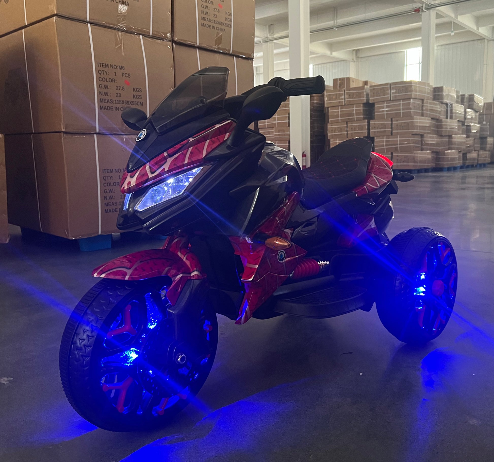 Black and red toy motorcycle on a indoor background