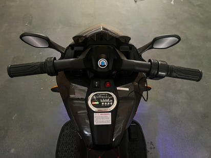 Black and red toy motorcycle on a indoor background