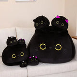 Round black cat plush pillows displayed in multiple sizes