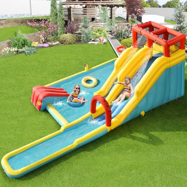 Inflatable water slide with pool and slide on grassy area
