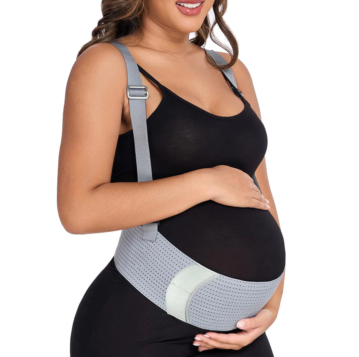 Woman wearing a gray maternity belt on a white background