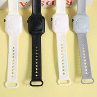 Four different colored watch straps on a yellow background