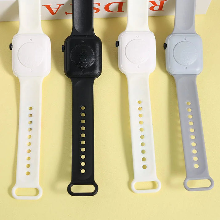 Four different colored watch straps on a yellow background