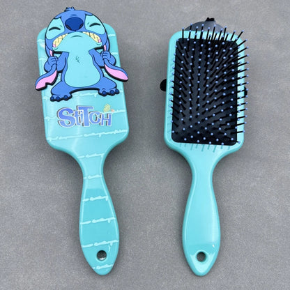 Blue hairbrush with cartoon character on a gray background