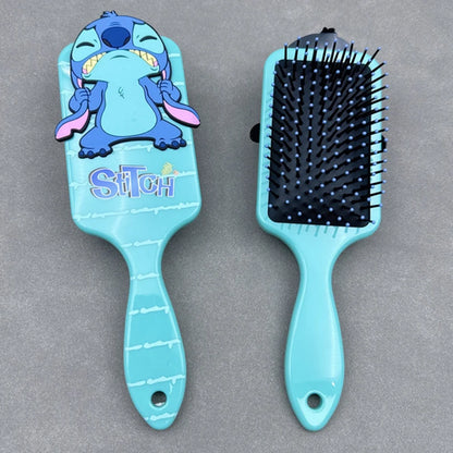 Blue hairbrush with cartoon character on a gray background