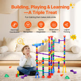 Child beside an assembled colorful marble run