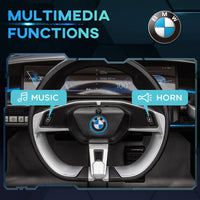 BMW car interior with multimedia functions labeled on a dark background