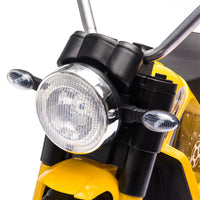 Close-up of a yellow motorcycle headlight with black housing on a white background
