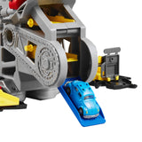 Mini car on blue ramp beside pretend engine components