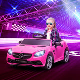 Child seated in pink SLC 300 ride-on car in a staged racing scene
