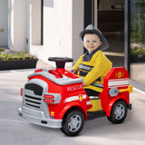 Child seated in the red ride-on fire truck wearing a firefighter costume