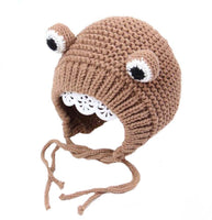 Knitted brown animal hat with white accents on a white background