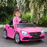 Child seated in the pink SLC 300 ride-on outdoors