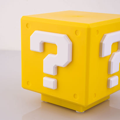 Yellow cube with question marks on a white background