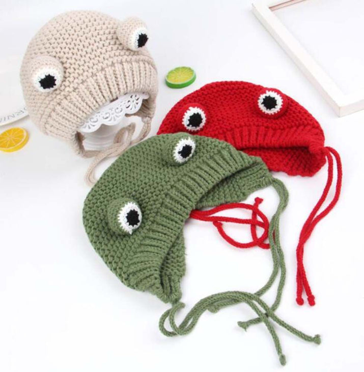 Three colorful knitted hats shaped like jellyfish on a white background