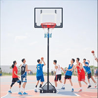 Basketball game in progress with players on an outdoor court