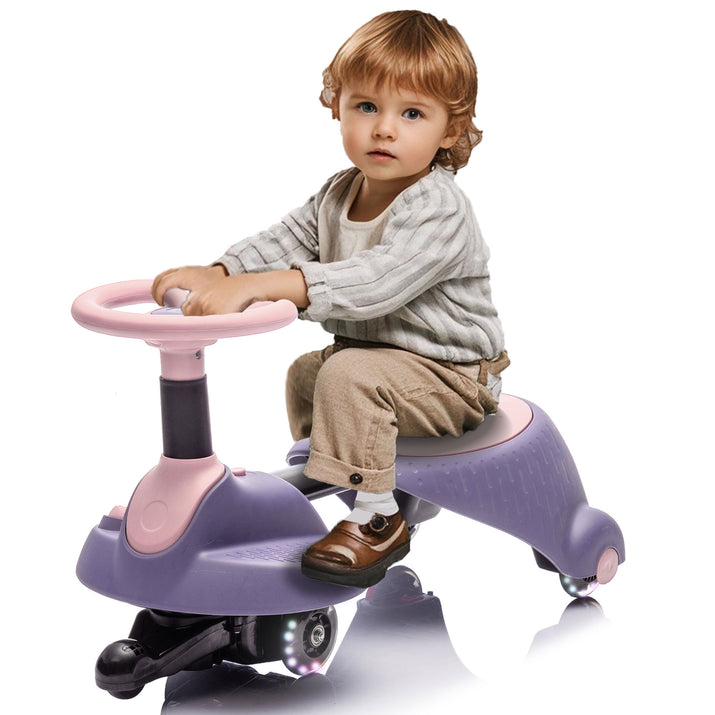 Child sitting on a purple and pink toy car with a white background